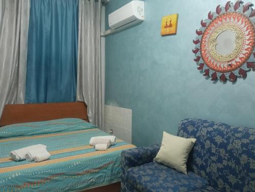 a bedroom with a bed and a chair and a mirror at Casa Akira Margot in Floridia