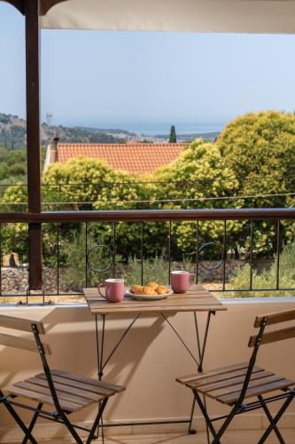 a table with a plate of food on a balcony at Melitini's Villa in Argostoli