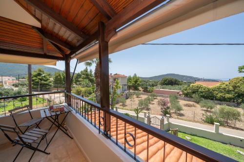 a balcony with a table and chairs and a view at Melitini's Villa in Argostoli