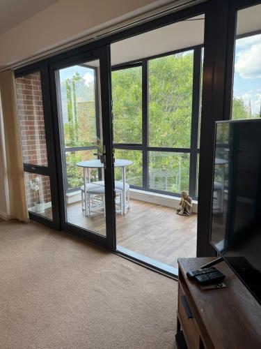 a living room with a sliding glass door at Uxbridge-Modern 2 bed Apt with Lift & Parking in Uxbridge