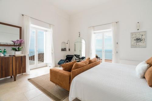 a bedroom with a large bed and a couch at Villa Magia in Positano