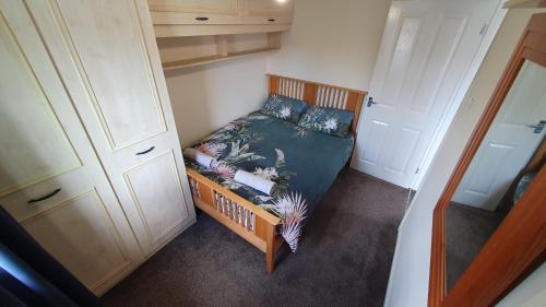 an overhead view of a small bedroom with a bed at Beautiful 3 bedroom House Manchester in Little Hulton