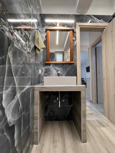 a bathroom with a sink and a mirror at Danita Apartments in Paleros