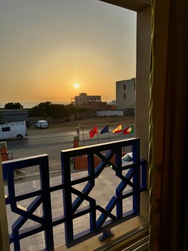 a balcony with a table with flags on it at La Perle De Briech in Asilah