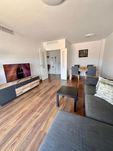a living room with a couch and a flat screen tv at Apartment in campello Beach in El Campello