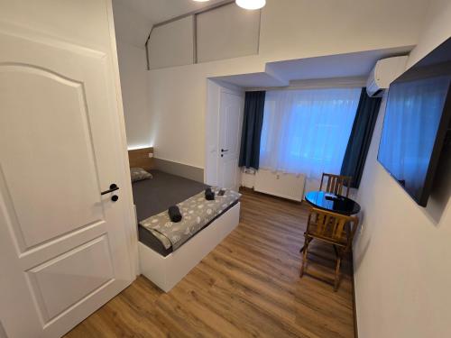 a room with a couch and a chair and a door at Delux apartment ARSO in Velenje