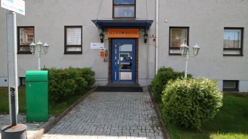 a building with a blue door in front of it at Mango Hotel in Tampere