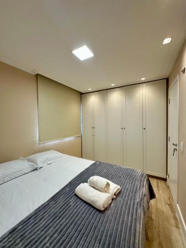 a bedroom with a bed with a towel on it at Apartamento condomínio clube in São Luís