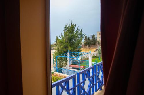 a view of a playground from a window at La Perle De Briech in Asilah