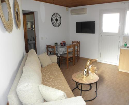 a living room with a white couch and a table at Angela's Nest in Chios