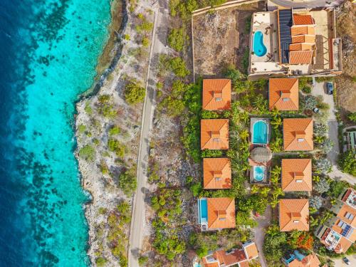an aerial view of a resort complex next to the water at Villa Happy Turtle with a spectacular ocean view in Kralendijk