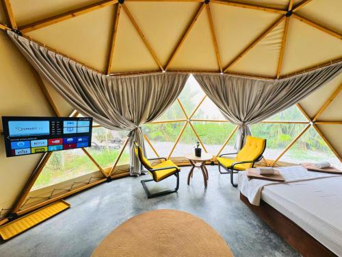 a room with a bed and chairs and a large window at In Out in Antalya