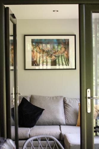 a living room with a couch and a picture on the wall at River Logie Lodges in Westfield