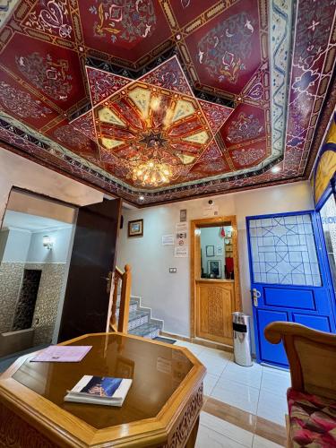 a room with a ceiling with a painting on it at La Perle De Briech in Asilah