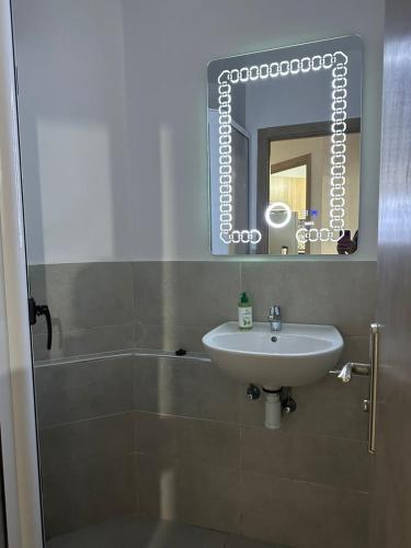 a bathroom with a sink and a mirror at Superbe appartement Anza in Agadir