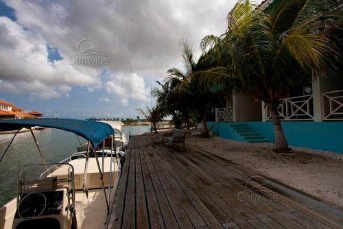 a boat parked on a dock next to a house at El Trupial in Kralendijk