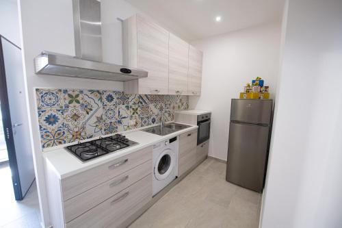 a kitchen with a stove and a refrigerator at La Trinacria in Terrasini