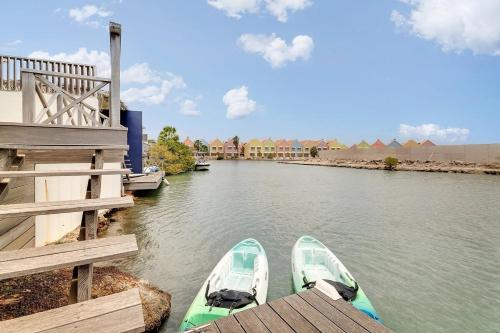a couple of boats are parked at a dock at Casa Pimienta in Water Villas in Kralendijk