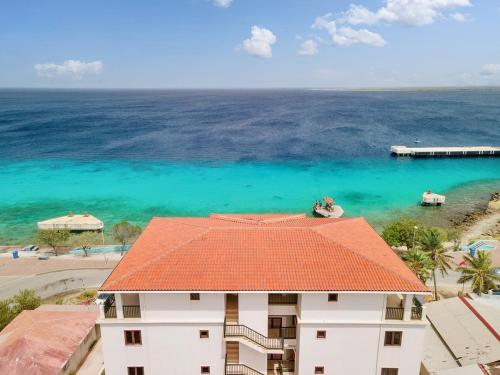 an aerial view of a building and the ocean at Penthouse on the Bay in Chachacha Beach Apartments in Kralendijk