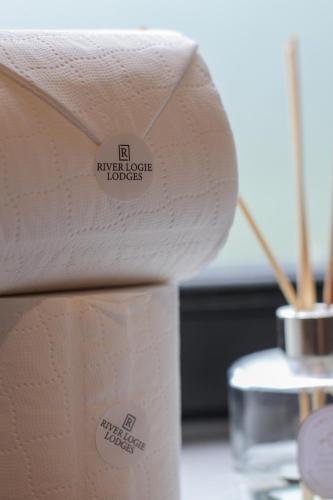 a roll of paper towels sitting on a table at River Logie Lodges in Westfield