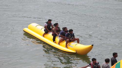 a group of people riding on a yellow raft in the water at Ranga Holiday Resort in Bentota