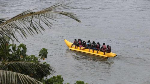 a group of people on a banana boat in the water at Ranga Holiday Resort in Bentota