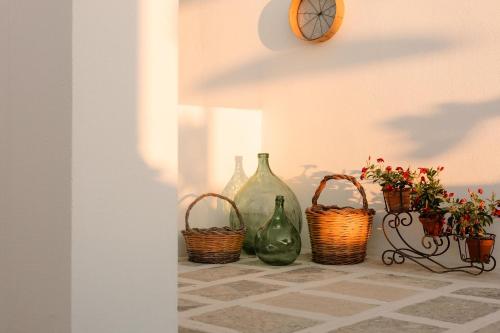 a group of vases and baskets sitting on a table at Dimora Le Tre Muse Guesthouse in Lecce