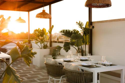 a restaurant with a white table and chairs at Dimora Le Tre Muse Guesthouse in Lecce