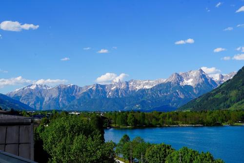 a view of a lake with snow capped mountains at Appartement Alpensee in Zell am See