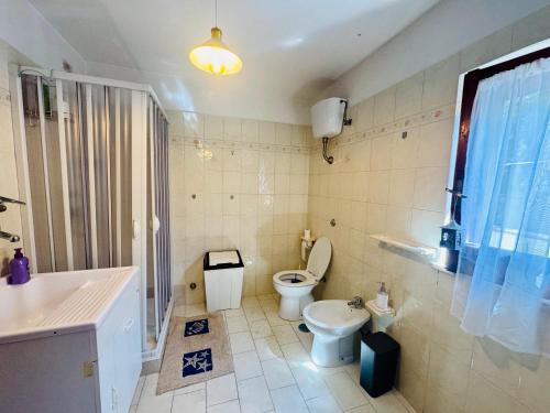 a bathroom with a toilet and a sink at Casa limone Anna e Clemente Cilento in Sapri