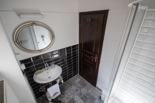 a bathroom with a sink and a mirror at Hotel Ovo malo duše in Sarajevo