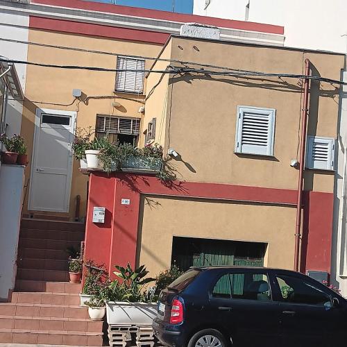 a black car parked in front of a house at Casa Nashi in Ugento