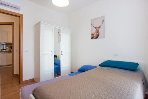 a bedroom with a bed and a white cabinet at Casa Vacanze da Bea in Tavullia