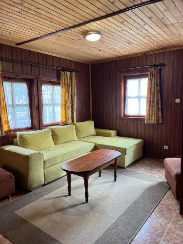 a living room with a couch and a coffee table at Complex Popangelov in Borovets
