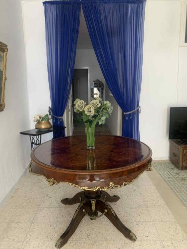 a table with a vase of flowers on top of it at Maison SidiBouSaid in Tunis