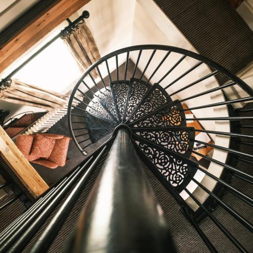 a spiral staircase in a building with a window at The Stag Rooms in Stratford-upon-Avon