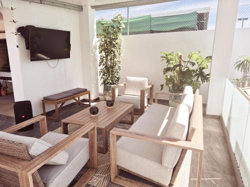 a living room with wooden furniture and a flat screen tv at Fernando Pessoa Villa in FAO