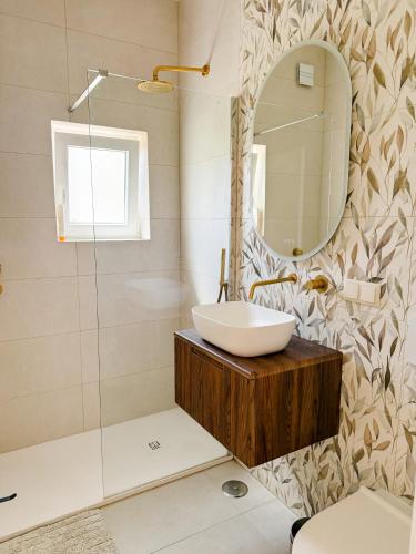 a bathroom with a sink and a mirror at Fernando Pessoa Villa in FAO