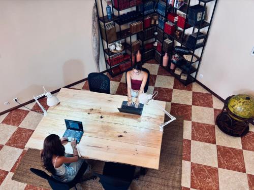 two women sitting around a table with a laptop at Ocean House in Ferrel