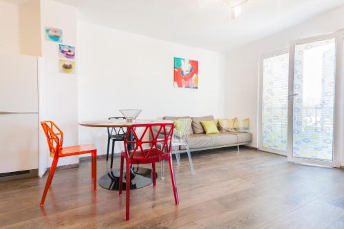 a living room with a table and chairs and a couch at Apartment Mia in Sveti Stefan