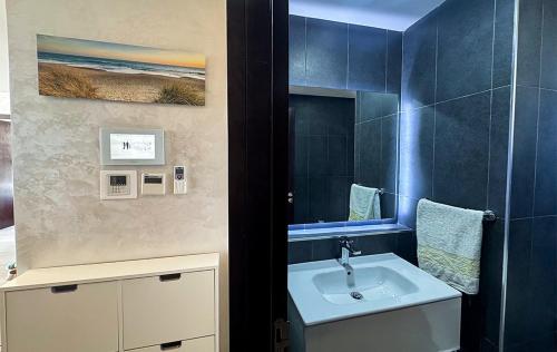 a bathroom with a sink and a mirror at Modern&Luxe Apt in Taghazout Bay in Taghazout
