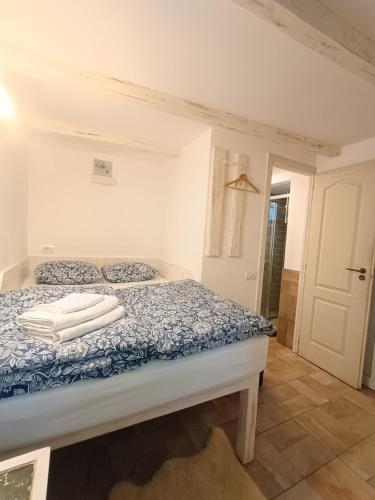 a bedroom with a bed with towels on it at The Bungalow in Braşov