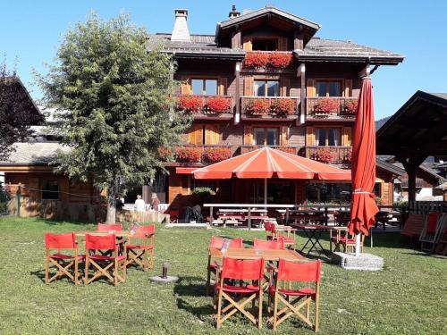 a group of chairs and umbrellas in front of a building at Résidence Frond'Neige in Morzine