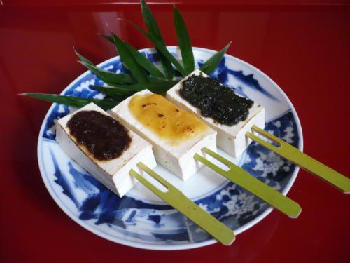 a blue and white plate with food on it at Gokayama Onsen Akaokan in Nanto