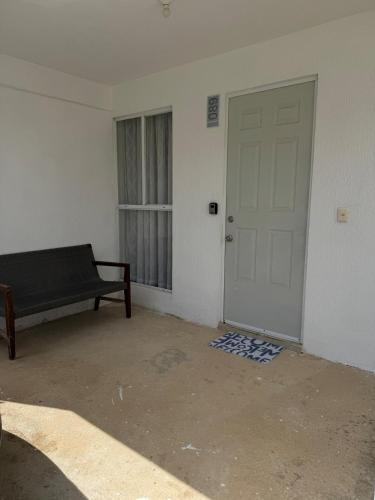 a room with a door and a couch and a window at House in front of the Maya Playa del Carmen train in Cedro