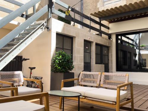 two chairs and a table on a patio at Hotel de Paris in La Rochelle