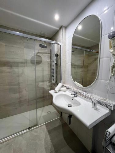 a bathroom with a shower and a sink and a mirror at La Ermita in Brunete