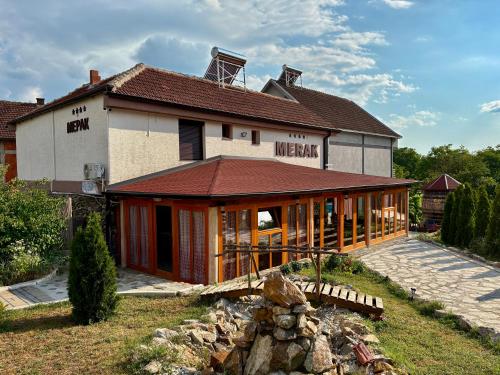 a large house with a wrap around porch at MERAK STD in Vranje