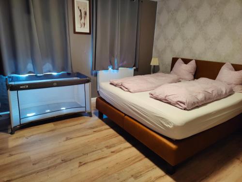 a bedroom with a bed with a fish tank on it at Ferienhaus am Sauerbrunnen in Daun