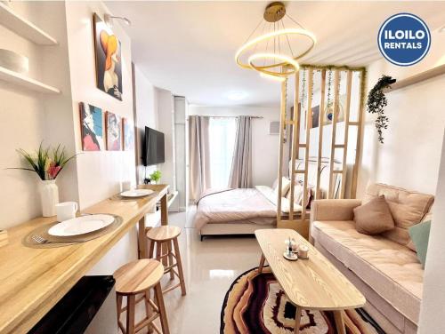 a living room with a kitchen and a living room with a couch at Modern Studio Comfort at Bernwood Tower in Iloilo City